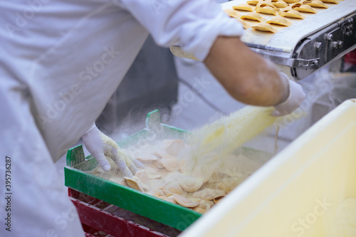 Pasta production – work at the Ravioli machine station.