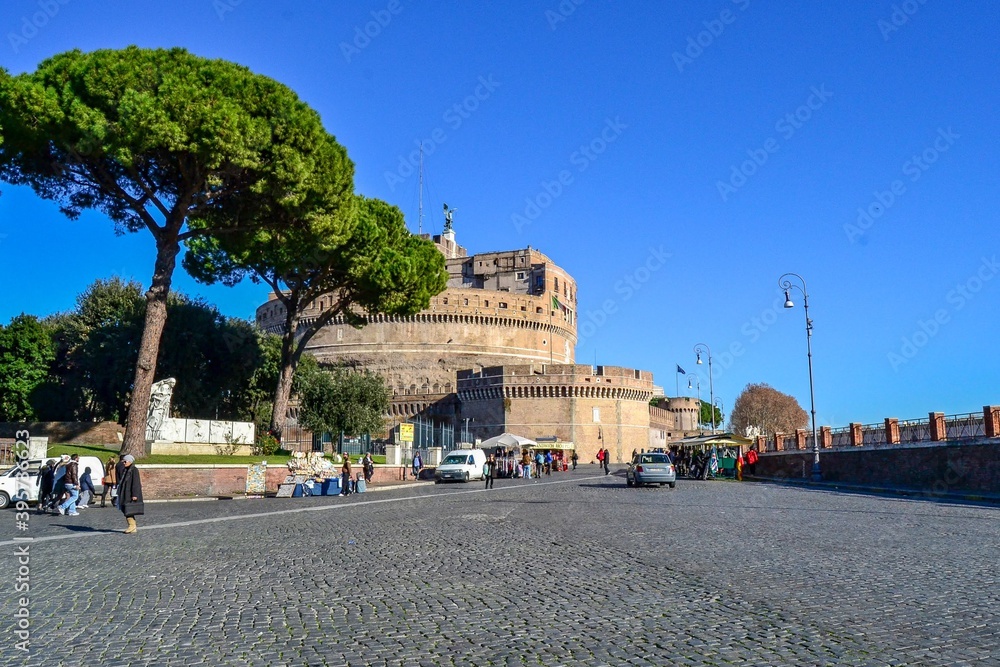 ITALY, ROME, 23.12.2011. Castel Sant'angelo and cobblestone street many people walking around near the castle and river, which is one most touristic place in Rome.