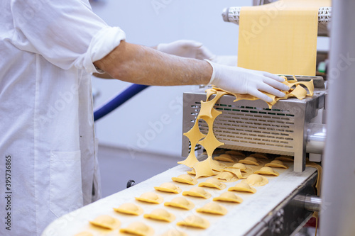 Pasta production – work at the Ravioli machine station.