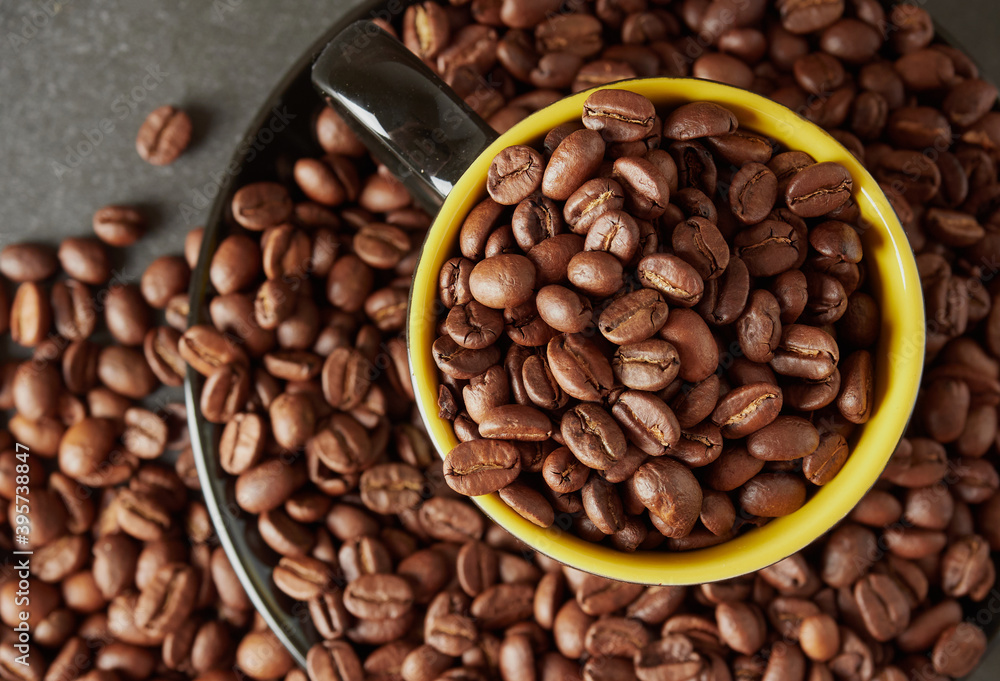 Fototapeta premium Coffee beans and hot coffee on the table