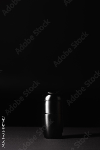 urn with ashes on black , funeral concept