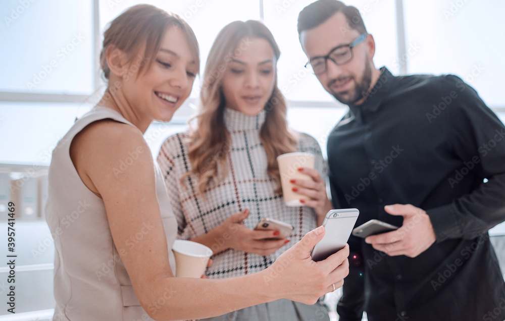 business team reading emails on their smartphones. business team reading emails on their smartphones.