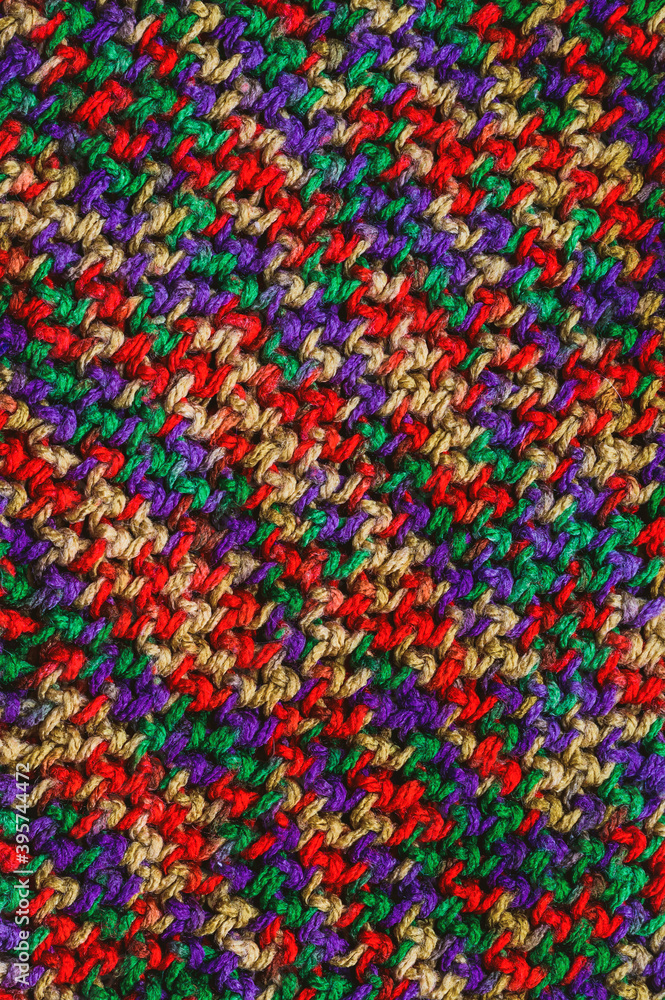 woolen scarf close up - vertical fabric background. Multicolored threads