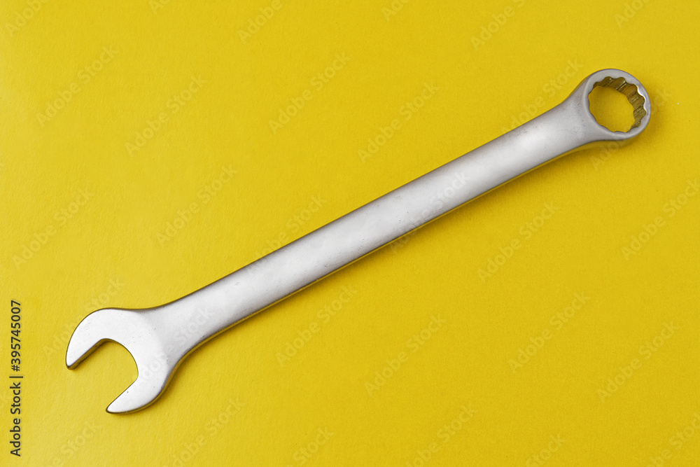 Open-end wrench on yellow background close-up Open-end wrench on yellow background close-up