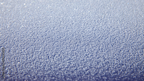 Icy texture on car hood in winter