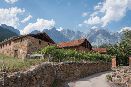 Old buildings against mountains in Mogrovejo town, Spain photo