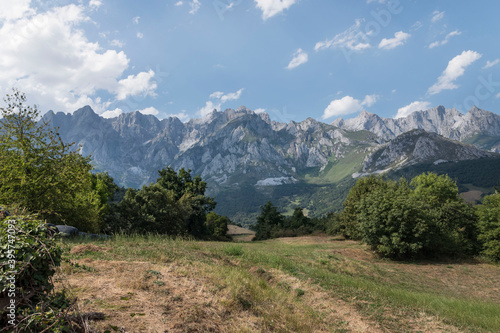 Landscape view of the green fields and mountains in Mogrovejo, Spain on a sunny day photo