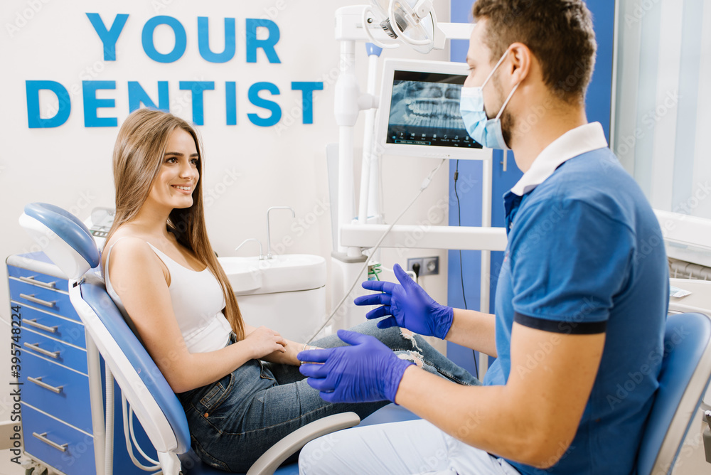 Fototapeta premium Man dentist having discussion with woman patient