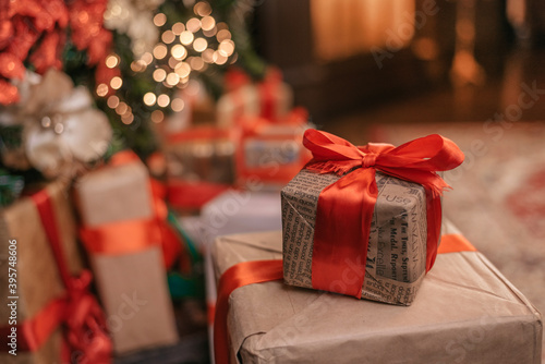 Beautiful Christmas gift boxes on floor near fir tree in room. space for text