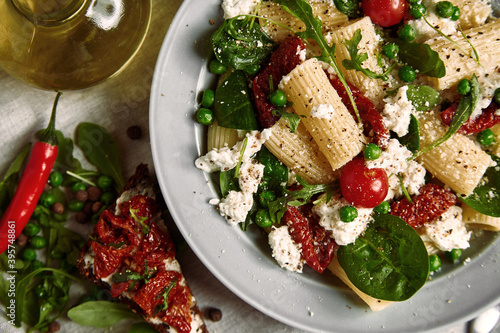 Calabrian chili and burrata pasta with peas close-up