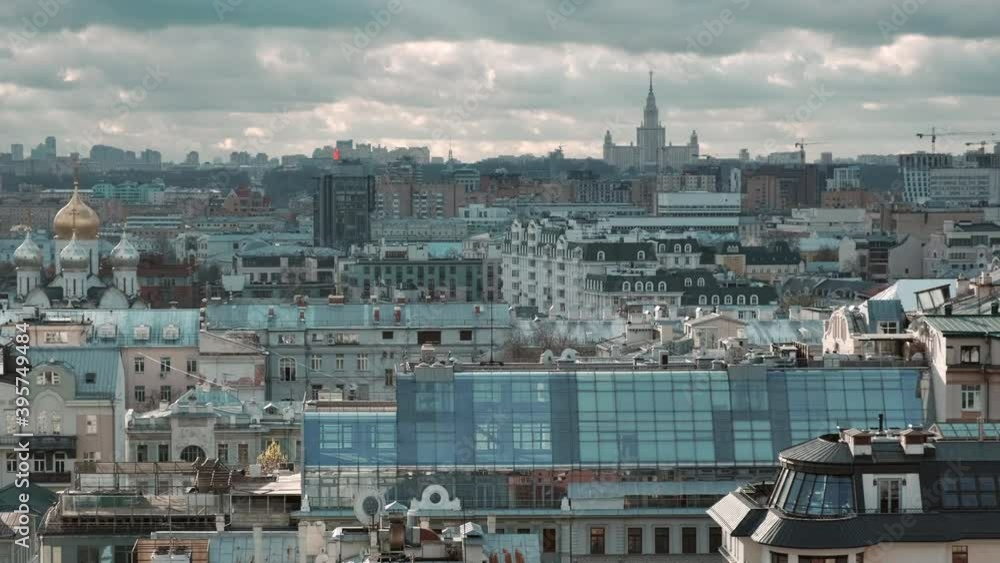 Panoramic view of the roofs of the Moscow central district. Old historical buildings and new houses, churches and factories. Cloudy day Panoramic view of the roofs of the Moscow central district. Old historical buildings and new houses, churches and factories. Cloudy day