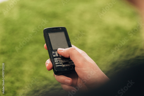 Girl Holds An Old Button Phone In Her Hand