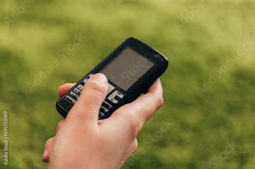 Girl Holds An Old Button Phone In Her Hand