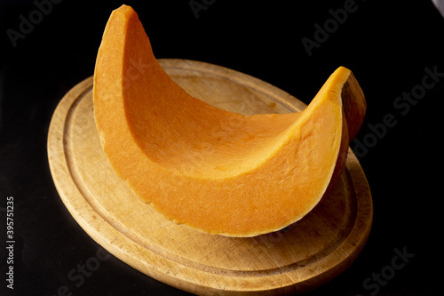 fresh pumpikin on a wooden chopping board photo