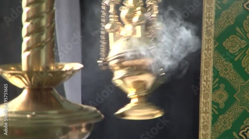 Candles and censer at the service in the village church.