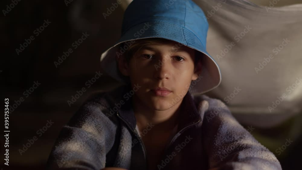 serious bully boy sitting indoors and looking at the camera serious bully boy sitting indoors and looking at the camera