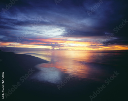 Sunset and Overcast Sky Over Beach © moodboard