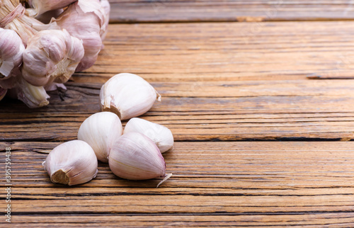 Fresh garlic on a vintage table With peeled and bunched garlic together