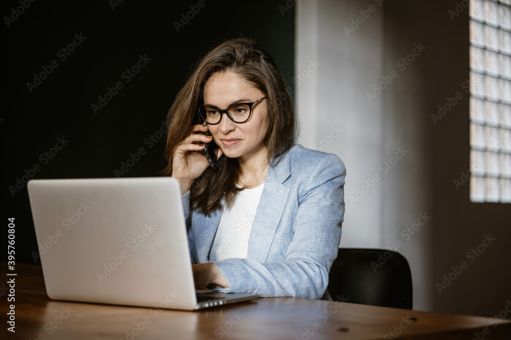 A woman at work does business on a laptop. Woman businessman working on laptop in office. Student in glasses to study on a laptop, vide connection. A woman at work does business on a laptop. Woman businessman working on laptop in office. Student in glasses to study on a laptop, vide connection.
