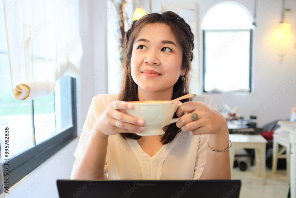 Happy Young Beautiful Asian Woman Using Laptop and Drink Latte Coffee Happy Young Beautiful Asian Woman Using Laptop and Drink Latte Coffee