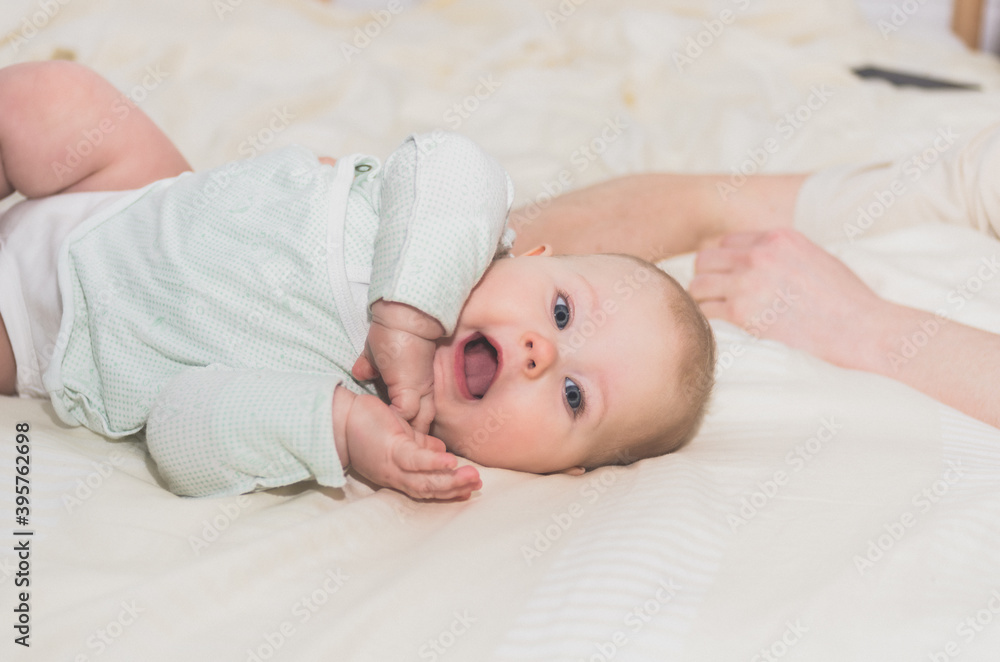 Little baby with open mouth cute lies on the bed Little baby with open mouth cute lies on the bed