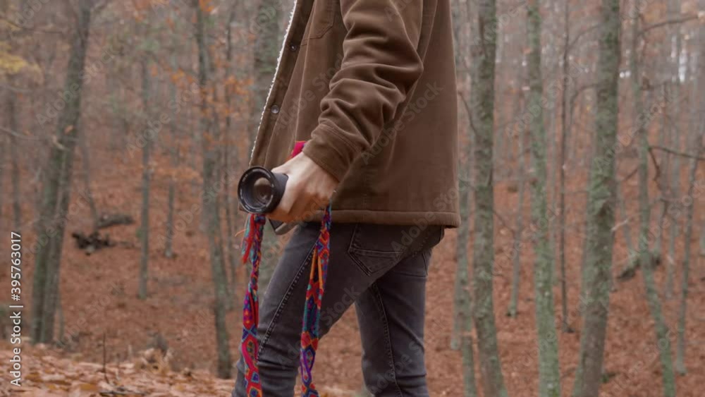 Medium shot Caucasian boy in forest with red and orange autumn leaves photographing with a professional camera photographer learning Medium shot Caucasian boy in forest with red and orange autumn leaves photographing with a professional camera photographer learning