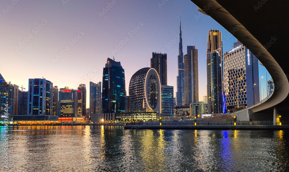 Downtown Dubai modern cityscape skyline view from the Marasi marina in the Business Bay at sunset in the United Arab Emirates