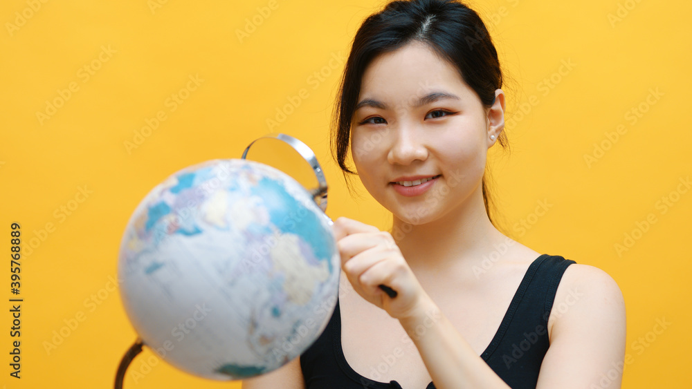 Young asian woman spy, holding globe and magnifying glass . Investigation and inspection. High quality photo Young asian woman spy, holding globe and magnifying glass . Investigation and inspection. High quality photo