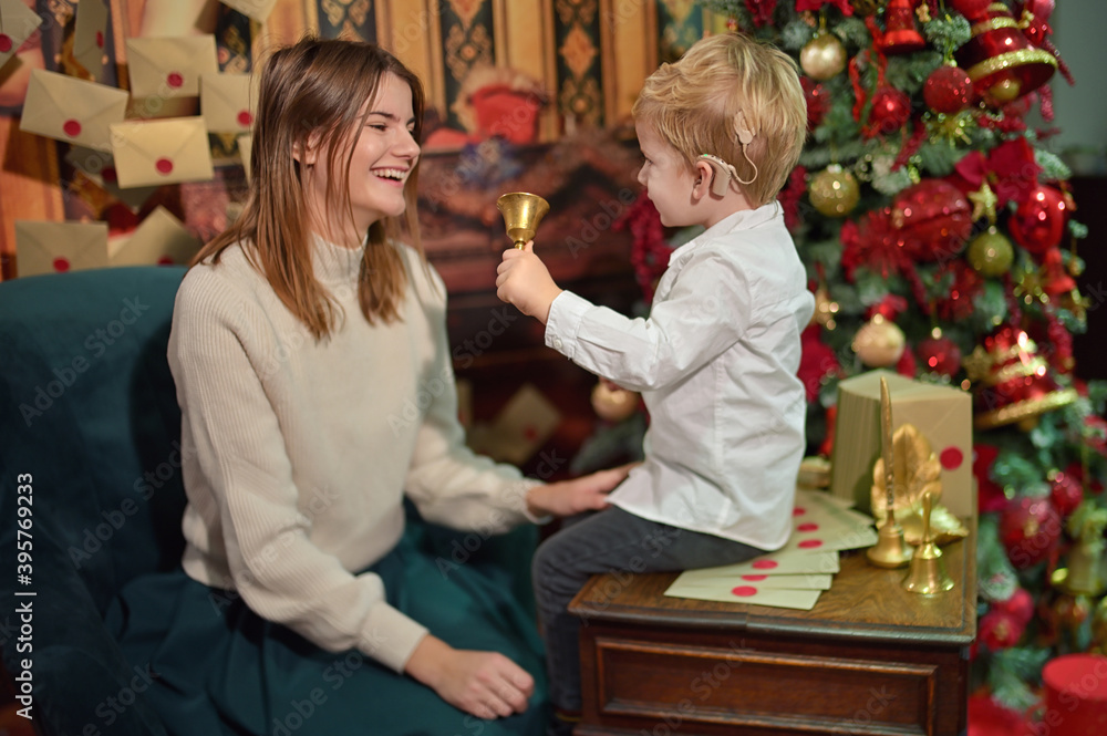 A Boy with Cochlear Implants play with Christmas Bell