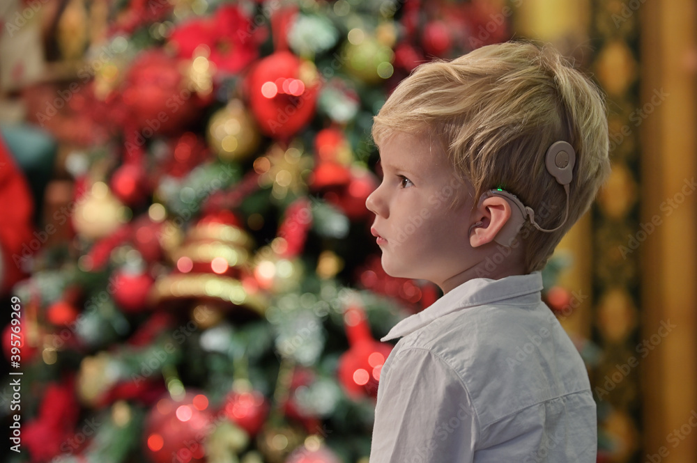 A Boy with Cochlear Implants and Christmas tree