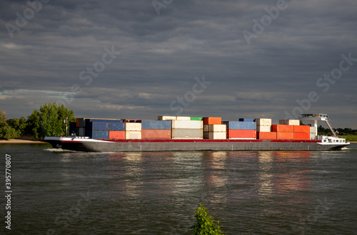 Inlandshipping container vessel transportation containers over the river in the Netherlands Waal River photo