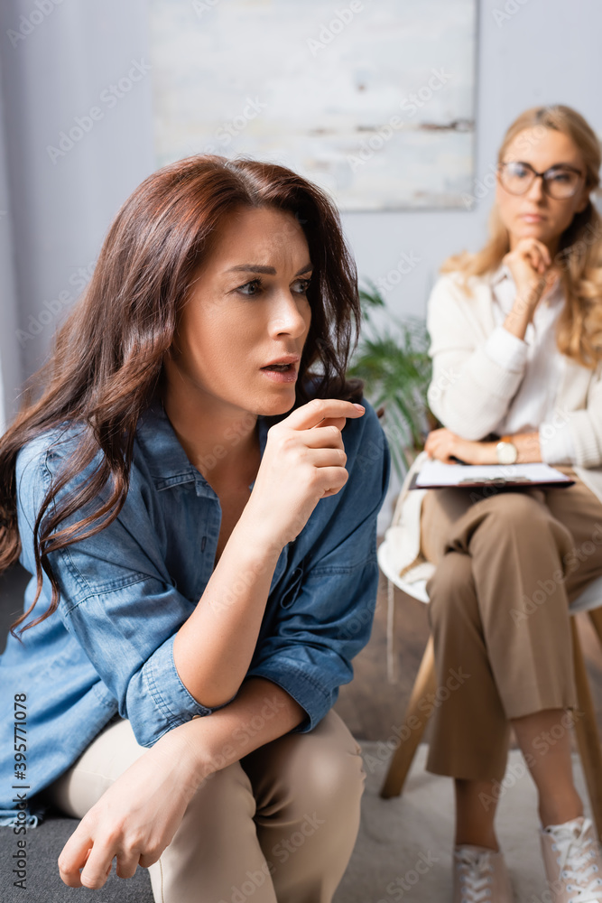 brunette woman with mental problem telling story to therapist brunette woman with mental problem telling story to therapist