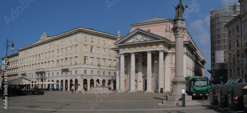 Panorama of Piazza della Borsa in Trieste, characterized by the Tergesteo building, column with the statue of emperor Leopold, the fountain of Neptune and the Palazzo della Borsa
