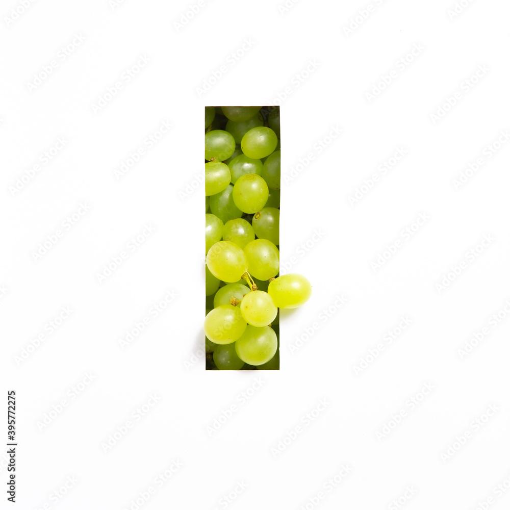 Letter I of English alphabet of fresh grape and cut paper isolated on white. Green berries typeface for festive design