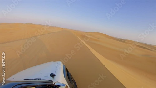 Desert safari off road, cockpit view from cabin or car. Jeep or SUV or 4x4 vehicle rides on desert dune barkhan or sand-dune photo