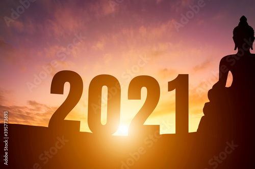 Happy New Year 2021, Silhouette Buddha statue early morning sunrise over the horizon background,Happy new year concept.