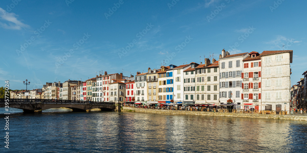 Colorful building facades along the Nive river, in Bayonne, France