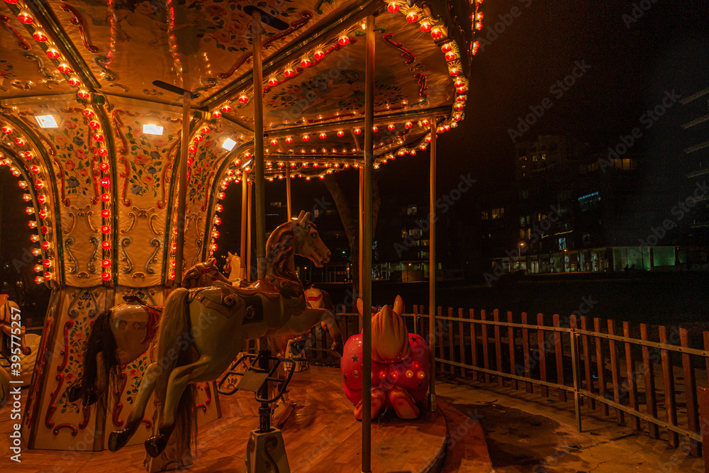 Fonte Nova's garden with Christmas market and colored ferris wheel near Ria de Aveiro at night