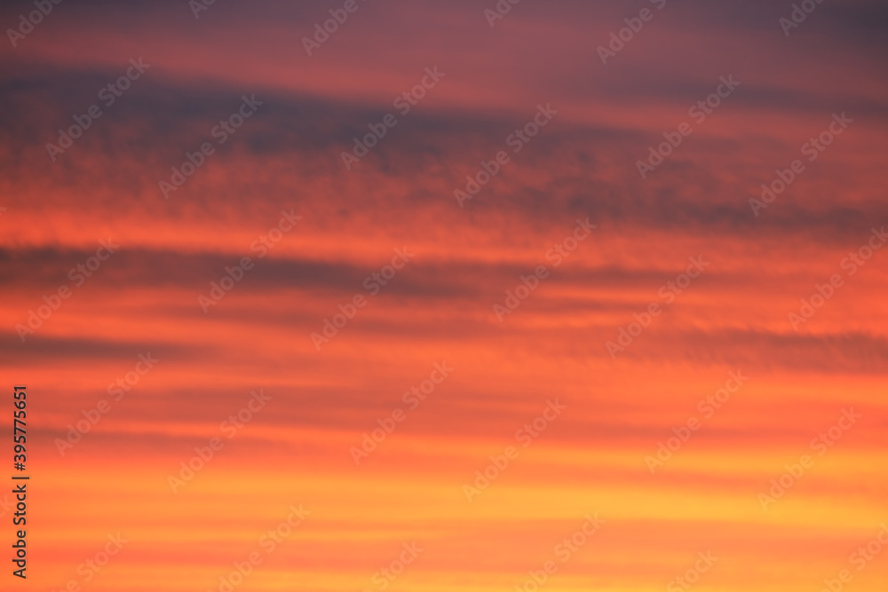 sunrise/sunset clouds in sky with colourful red and orange hues. Beautiful background.