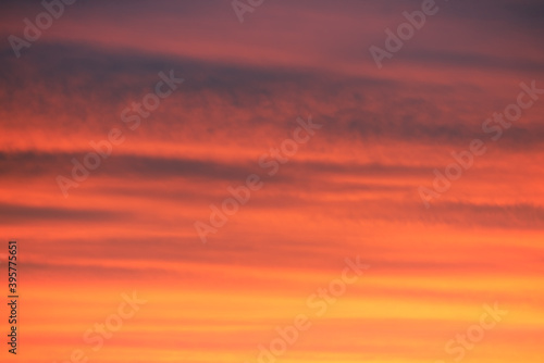 sunrise/sunset clouds in sky with colourful red and orange hues. Beautiful background. © _Danoz