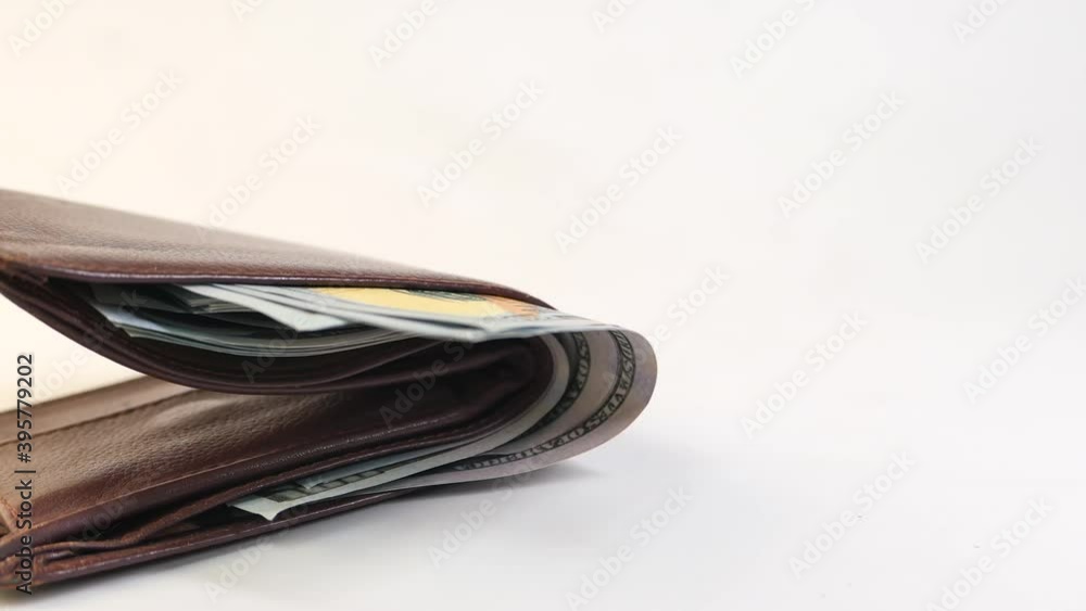 Close up of cash in wallet on table. Close up of cash in wallet on table.