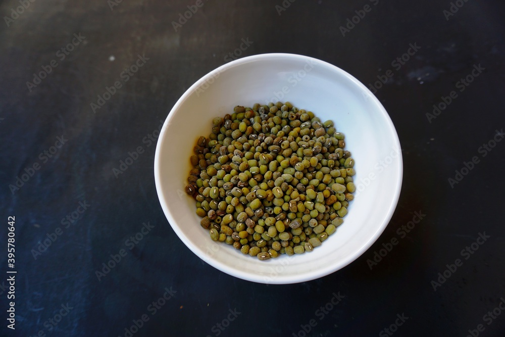 Mung beans, or scientific name Vigna radiata on the background of dried green beans. Protein-rich vegetarian food. Healthy food concept. Mung beans, or scientific name Vigna radiata on the background of dried green beans. Protein-rich vegetarian food. Healthy food concept.