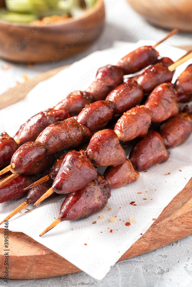 Grilled chicken hearts on a skewer close-up. Grilled chicken hearts on a skewer close-up.
