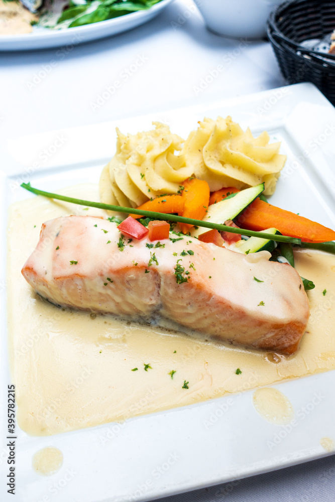 Grilled salmon and lemon - french cuisine dish with tomato and salmon