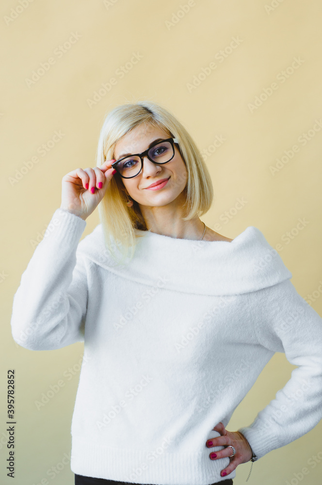 Portrait of pleased attractive smiling Cute young European woman holding cat-eye glasses posing, isolated over light green studio background. Stylish curly blonde young European woman holding specks Portrait of pleased attractive smiling Cute young European woman holding cat-eye glasses posing, isolated over light green studio background. Stylish curly blonde young European woman holding specks