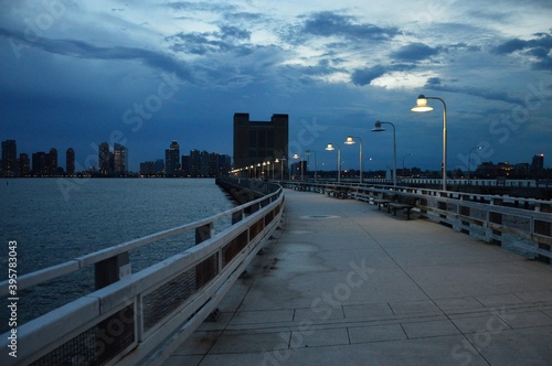 New York city skyline and pier by Hudson river in the evening in summer 
