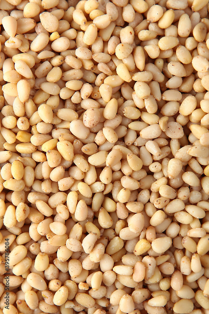 Pine nuts, without shells, in large quantities. Natural product. The view from the top. Copy space. Pine nuts, without shells, in large quantities. Natural product. The view from the top. Copy space.