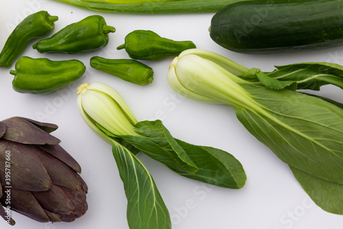 Cucumber, peppers and chicory on white background