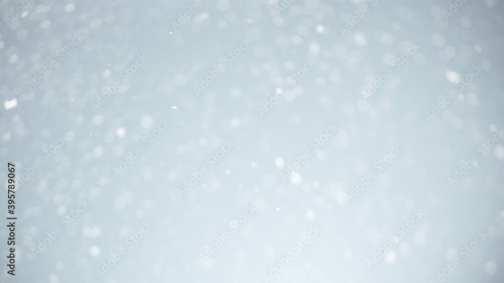 Super Slow Motion Shot of Real Snow Falling on Silver Christmas Background at 1000 fps.