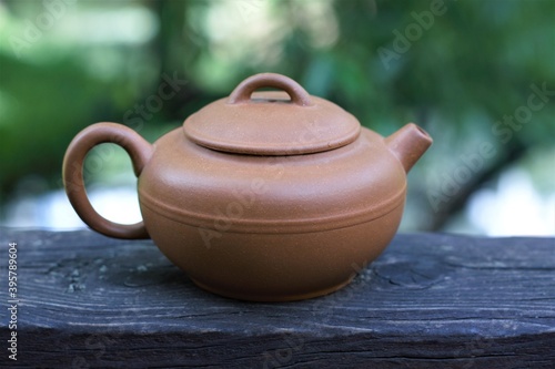 clay teapot on a wooden table